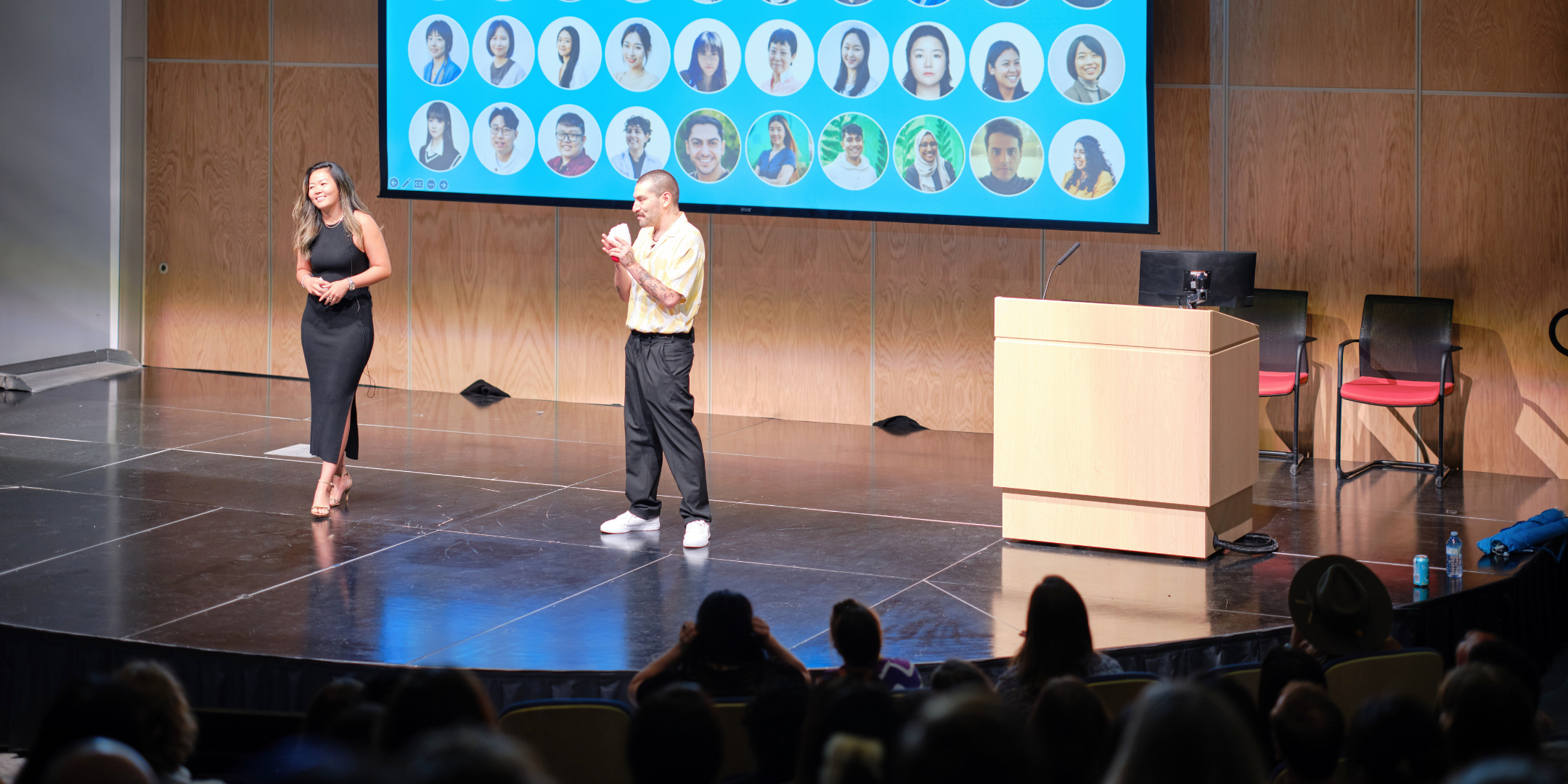two students on stage giving presentation