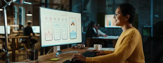 Designer at desk looking at screen