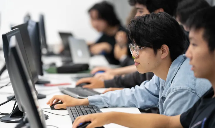 Teenagers looking at a computer