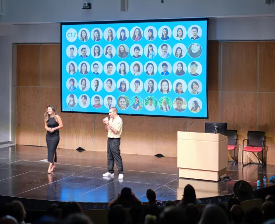 two students standing on stage