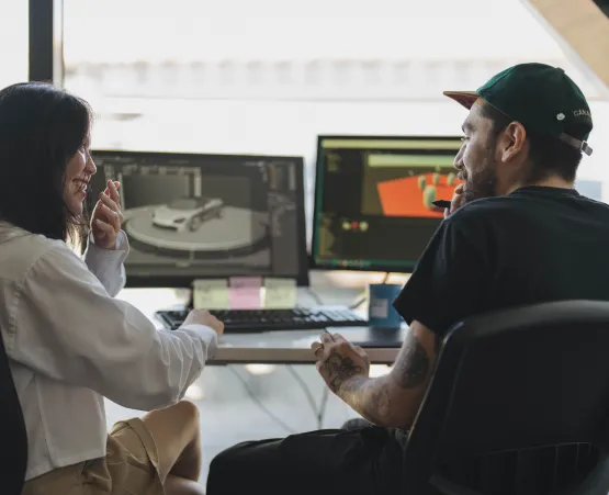 Two students looking at computer