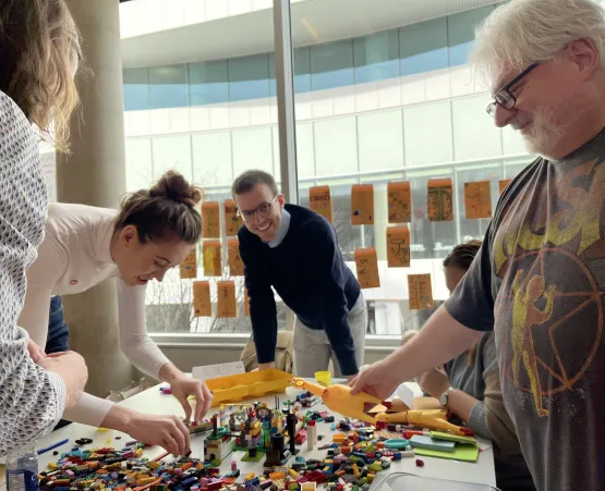 Group of people building Lego