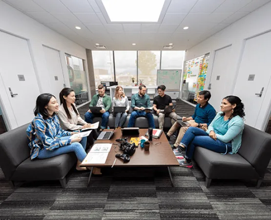 a group of student collaborating around a table