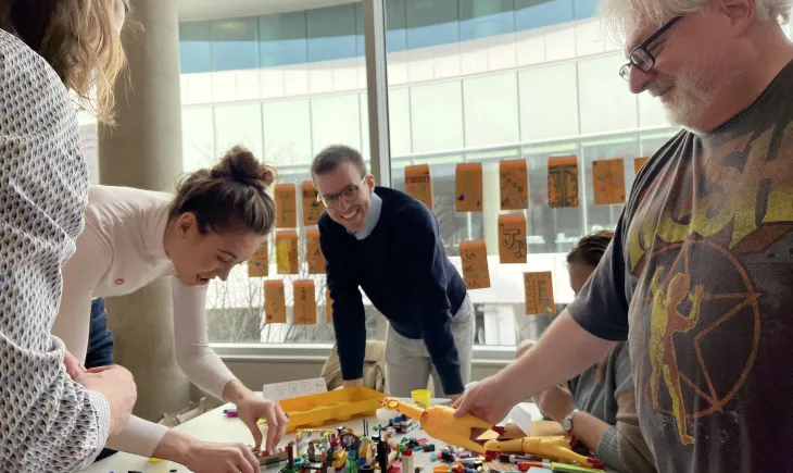 Group of people building Lego